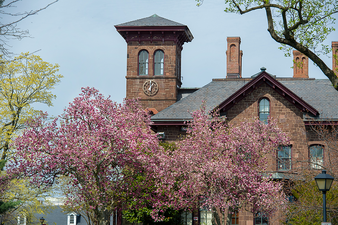 View of College Hall surrounded by emerging cherry blossoms in New Brunswick on the Douglass Campus.